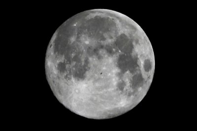 Look closely to see the International Space Station crossing the plains of the moon.